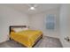Cozy bedroom with a queen bed, carpet, white walls, and natural light from the window at 4057 Sagefield Dr, Harmony, FL 34773