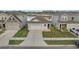 Charming single-story home featuring a gray exterior, attached garage, and manicured front yard with a pond view at 4057 Sagefield Dr, Harmony, FL 34773