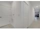 Bright hallway with white walls, closet, and tile flooring leading to the living area at 4057 Sagefield Dr, Harmony, FL 34773