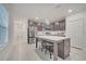 Modern kitchen featuring a center island with seating, stainless steel appliances, and tile flooring at 4057 Sagefield Dr, Harmony, FL 34773