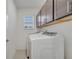 This spacious laundry room features cabinets, shelving, and a window for natural light at 4057 Sagefield Dr, Harmony, FL 34773