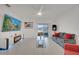 Comfortable living room with tile flooring, gray couch, TV, and sliding glass doors at 4057 Sagefield Dr, Harmony, FL 34773