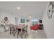Open-concept living room with tile flooring, dining table, and modern decor at 4057 Sagefield Dr, Harmony, FL 34773
