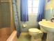 Bathroom boasts blue tile, a shower-tub combo, and classic fixtures at 420 W Crystal Dr, Sanford, FL 32773