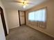 A simple bedroom shows carpeted floors, a ceiling fan, and a closet for storage at 420 W Crystal Dr, Sanford, FL 32773