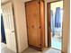 Hallway leads to a tiled bathroom and features a floor-to-ceiling storage cabinet at 420 W Crystal Dr, Sanford, FL 32773