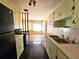 Vintage-style kitchen with linoleum flooring, retro appliances, and classic cabinetry at 420 W Crystal Dr, Sanford, FL 32773