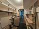 Functional laundry room with storage shelves and washer-dryer hookups at 420 W Crystal Dr, Sanford, FL 32773