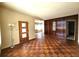 Inviting living room featuring parquet flooring, wood wall accents, and a view into the dining area at 420 W Crystal Dr, Sanford, FL 32773