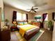 Staged main bedroom with mid-century modern furniture and colorful accents at 420 W Crystal Dr, Sanford, FL 32773