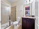 This bathroom features a glass shower, toilet and vanity with granite counters at 431 Novi Path, Kissimmee, FL 34747
