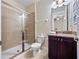 Bathroom with a glass-enclosed shower, dark wood vanity, and granite countertop at 431 Novi Path, Kissimmee, FL 34747
