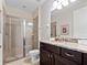 This well lit bathroom features a glass shower and granite topped vanity at 431 Novi Path, Kissimmee, FL 34747