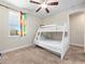 Bright bedroom featuring a white bunk bed, beige carpet, and playful Lego-themed curtains at 431 Novi Path, Kissimmee, FL 34747