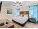 This bedroom features a large bed, ceiling fan, and decor at 431 Novi Path, Kissimmee, FL 34747