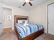 Bedroom featuring a ceiling fan, and a bed with blue striped bedding at 431 Novi Path, Kissimmee, FL 34747
