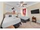 Nicely decorated bedroom with two beds, mickey mouse art and a ceiling fan at 431 Novi Path, Kissimmee, FL 34747