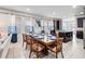 Dining room with large table and many windows with blue and white curtains at 431 Novi Path, Kissimmee, FL 34747