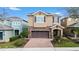 Charming two-story home with a brick driveway, attached two-car garage, and lovely landscaping at 431 Novi Path, Kissimmee, FL 34747