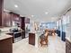 Open kitchen and dining area with stainless steel appliances and granite countertops at 431 Novi Path, Kissimmee, FL 34747