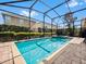 Inviting screened-in pool and spa area with brick pavers, perfect for relaxation and outdoor enjoyment at 431 Novi Path, Kissimmee, FL 34747