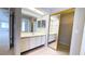 Bathroom with white vanity, large mirror, and mirrored closet doors at 4448 Pinebark Ave # 56-1, Orlando, FL 32811