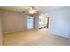 Bedroom with neutral walls and carpet, offering views into the bathroom at 4448 Pinebark Ave # 56-1, Orlando, FL 32811