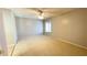 Bedroom featuring neutral walls, plush carpet, ceiling fan, and transom window at 4448 Pinebark Ave # 56-1, Orlando, FL 32811