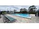 Relaxing community pool with ample lounge chairs and a large pool deck at 4448 Pinebark Ave # 56-1, Orlando, FL 32811