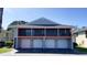 Condominium featuring private garages and balconies with black metal railing at 4448 Pinebark Ave # 56-1, Orlando, FL 32811