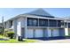Condo exterior with garages and a second-story screened in balcony at 4448 Pinebark Ave # 56-1, Orlando, FL 32811
