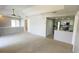 Open-concept living room and kitchen with white cabinets and stainless appliances at 4448 Pinebark Ave # 56-1, Orlando, FL 32811