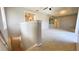 Spacious living room area with neutral walls, plush carpet, and ample natural light through doorways and transom windows at 4448 Pinebark Ave # 56-1, Orlando, FL 32811