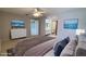 Bedroom with ceiling fan, TV, and access to the bathroom and walk-in closet at 4448 Pinebark Ave # 56-1, Orlando, FL 32811