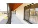 View of the screened in porch with three windows showing an outside view, light walls and gray floor at 4448 Pinebark Ave # 56-1, Orlando, FL 32811