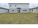 An expansive, grassy backyard offers ample space and features sliding glass doors at 4965 Kaia Ave, Winter Haven, FL 33884