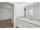 Modern bathroom with double sinks, granite countertops, and white cabinets for a bright and clean space at 4965 Kaia Ave, Winter Haven, FL 33884