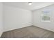 Neutral bedroom showcasing carpeted floors and a window offering natural light at 4965 Kaia Ave, Winter Haven, FL 33884