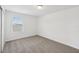 Bright bedroom with neutral carpet and a window providing natural light to the interior space at 4965 Kaia Ave, Winter Haven, FL 33884