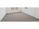 Bright bedroom featuring neutral carpet and several windows providing natural light to the interior space at 4965 Kaia Ave, Winter Haven, FL 33884