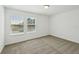 Well-lit bedroom with carpeting and view of a pond through two windows at 4965 Kaia Ave, Winter Haven, FL 33884