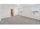Bright bedroom featuring neutral carpet, bright light and a doorway for a clean and modern aesthetic at 4965 Kaia Ave, Winter Haven, FL 33884