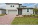 Charming two-story home featuring a brick driveway and inviting front lawn at 4965 Kaia Ave, Winter Haven, FL 33884