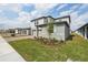 Modern two-story home with grey siding, brick driveway, and fresh landscaping at 4965 Kaia Ave, Winter Haven, FL 33884