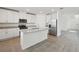Stylish kitchen with a granite island, stainless steel appliances, and white cabinetry at 4965 Kaia Ave, Winter Haven, FL 33884