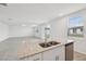 Bright kitchen with granite countertops, stainless steel appliances, and an open layout to the living area at 4965 Kaia Ave, Winter Haven, FL 33884
