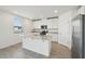 Modern kitchen featuring a center island, stainless steel appliances, and ample cabinet space at 4965 Kaia Ave, Winter Haven, FL 33884