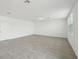 Large, bright living room with neutral tile flooring and ample natural light at 4965 Kaia Ave, Winter Haven, FL 33884