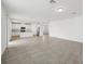 Expansive living area with modern tile floors, flowing into a bright, white kitchen at 4965 Kaia Ave, Winter Haven, FL 33884