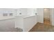 Bright loft area with neutral carpet, staircase and a bathroom for a clean and modern aesthetic at 4965 Kaia Ave, Winter Haven, FL 33884